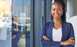 © JessicaLeigh J/peopleimages.com - Portrait, window and arms crossed with a business black woman standing in her professional office. Smile, corporate leadership with a happy female manager or boss in the workplace for empowerment