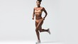 © MiguelAngel - Athletic young black woman as a runner on white background.