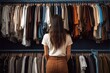 Rear view of young woman looking at clothes in wardrobe at home, A girl in loose fitting clothes is choosing clothes in a store, brown long hair, one hanger with a Tshirt in her hand, AI Generated