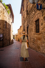 Beautiful female model on the old city streets of San Gimignano, Tuscany, Italy