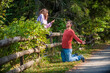 © guruXOX - Guy on his knees asking a girl to marry him, on a country road in nature. Funny scene