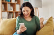 © Malik/peopleimages.com - Phone, win and celebration, happy woman on sofa with notification on bonus, deal or discount offer online. Wow, social media and girl on couch with smile, cellphone and excited for surprise in home.