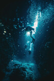 Fototapeta Do akwarium - Blurred underwater pictire with divers and coral reef