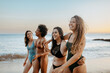 © Prostock-studio - Joyful girlfriends in swimwear walking on beach at sunset and enjoying free time together, laughing and chatting