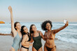 © Prostock-studio - Excited carefree multiracial ladies friends capturing moments spending time together at the beach