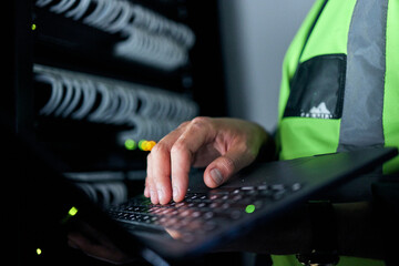 Hands, keyboard and typing for server, cables or man for inspection, coding or analysis in night for programming. Information technology expert, computer and keyboard for database, solution and test