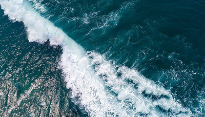 Spectacular aerial top view background photo of ocean sea water white wave splashing in the deep sea. Drone photo backdrop of sea wave in bird eye waves.