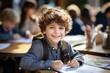 © omachucam - Preschooler boy drawing in notebook at table in middle class school education