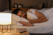 © New Africa - Handsome man sleeping in bed at night