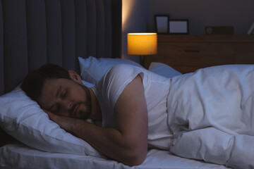 Poster - Handsome man sleeping in bed at night