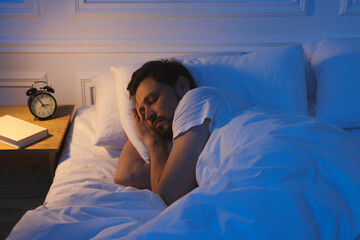 Wall Mural - Handsome man sleeping in bed at night