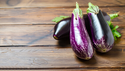 Fresh healthy raw Purple Eggplant on a kitchen wooden table. The concept of Diet menu.