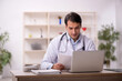© Elnur - Young male doctor in telemedicine concept