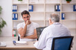 © Elnur - Young male patient visiting old male doctor radiologist