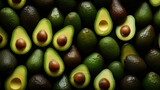 Fototapeta  - Top view full frame of whole ripe avocados placed together as background.