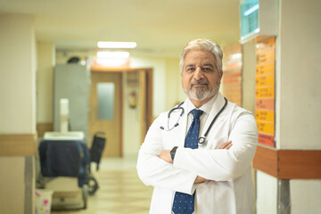 Wall Mural - Indian senior doctor standing in hospital.