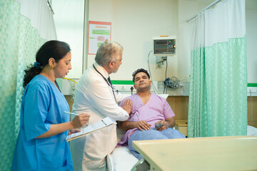 Wall Mural - Doctor check up to patient at hospital and asking to female assistant writing some medicine