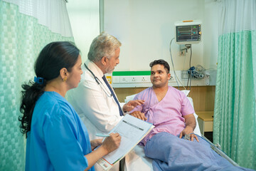 Wall Mural - Doctor check up to patient at hospital and asking to female assistant writing some medicine