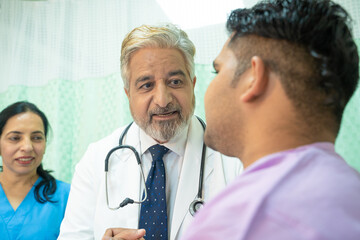 Wall Mural - Doctor checking patient at hospital.