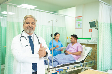 Wall Mural - Doctor showing thumps up at hospital.