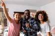 © WavebreakMediaMicro - Portrait of happy diverse friends dancing and singing at home
