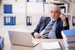 © Elnur - Old male employee working in the office