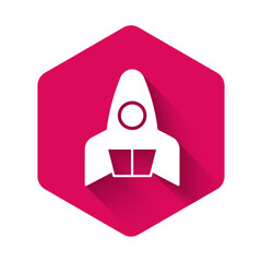 Canvas Print - White Rocket ship icon isolated with long shadow background. Space travel. Pink hexagon button. Vector