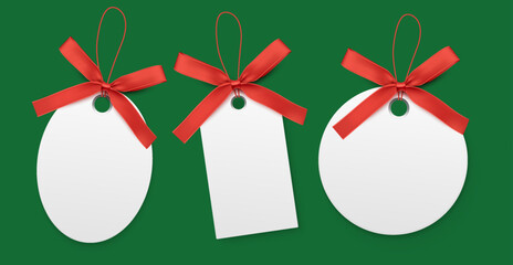 Wall Mural - Blank white labels with red bow isolated on green background.