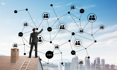 Wall Mural - businessman on house roof presenting networking and connection concept. mixed media