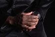 © ADDICTIVE STOCK - Unrecognizable black man in jacket touching smart watch on hand