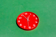 © ADDICTIVE STOCK - Red clock in green background