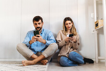 Couple Addicted To Smartphones Ignoring Each Other At Home. Relationship Problems
