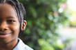 © Wavebreak Media - Portrait of happy african american boy with braids, smiling in garden, copy space