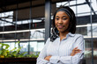 © Wavebreak Media - Portrait of a african american businesswoman with arms crossed standing at modern office