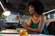© Wavebreak Media - African american woman having a snack sitting on her desk at office