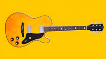 Electric Guitar On Yellow Background 