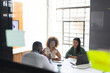© Wavebreak Media - Focused diverse colleagues at meeting discussing work with laptop in office