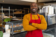 © Wavebreak Media - Portrait of happy african american male bakery worker wearing red apron with arms crossed