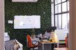 © Wavebreak Media - Sunny casual office with green wall with whiteboard