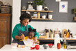 © Wavebreak Media - Happy african american mother and daughter baking pancakes in kitchen at home, copy space