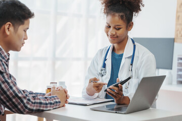 Wall Mural - You are now in a safe area. African american female doctor with patient, Wherever the art of Medicine is loved, there is also a love of Humanity.