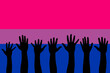 © elif - LGBTQI, trans and intersex rights concept. Human hands over Bisexual pride flag on background