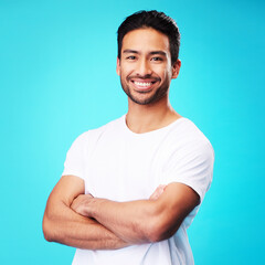 Wall Mural - smile, happy and portrait of asian man arms crossed with casual fashion isolated in a studio blue ba