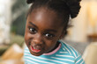 © Wavebreak Media - Portrait of happy african american girl wearing striped shirt