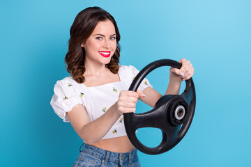 Canvas Print - Photo of cheerful positive girl dressed white top driving auto empty space isolated blue color background