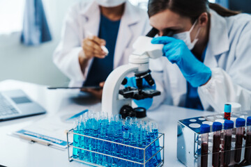 Health care researchers working in life science laboratory, Teaching in labs - Requiring students to record their laboratory methods and results as a running record of their laboratory work.