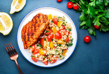 Grilled Chicken With Bulgur Tabbouleh Salad With Tomatoes, Parsley And Olive Oil And Lemon Dressing, Blue Stone Table Background, Top View