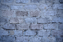 A Gray Wall Of Large Blocks. Grey Cinder Block. The Wall Of An Industrial Building.