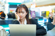 © eakgrungenerd - Women using laptop sitting coffee shop in shopping mall. Working lady relax positive expression cheerful. Female black suit working outside. Asia student learning via online with laptop.