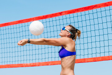 Wall Mural - Professional player woman playing volleyball on the beach. Horizontal sport theme poster, greeting cards, headers, website and app